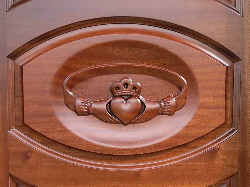 claddagh ring carved in mahogany door